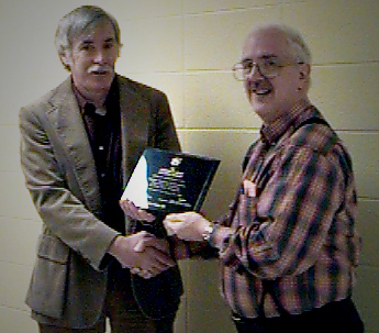 Dr. Harry Perlstadt, Commissioner, presenting a commemorative plaque to Dr. Jim Sherohman, Director of the first Applied Sociology program to be accredited
